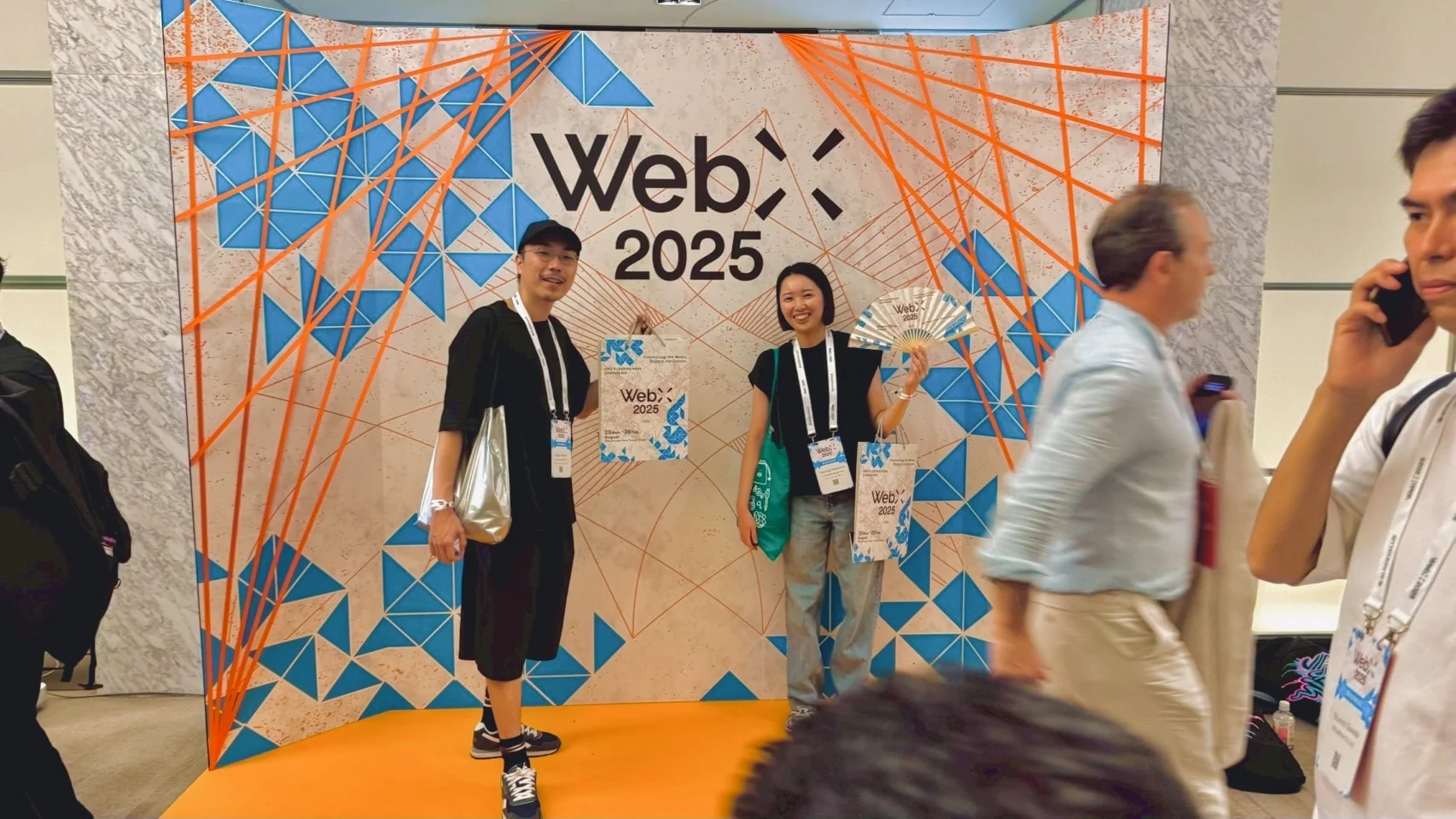 WebX 2025のロゴと幾何学模様を背面に配したTシャツ